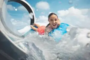 Young woman laughing on a water slide
