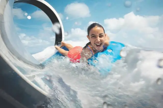 Young woman laughing on a water slide