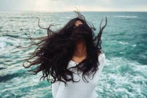 Woman standing in the wind. Itinerary changes due to weather