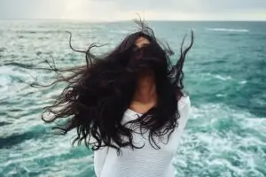Woman standing in the wind. Itinerary changes due to weather