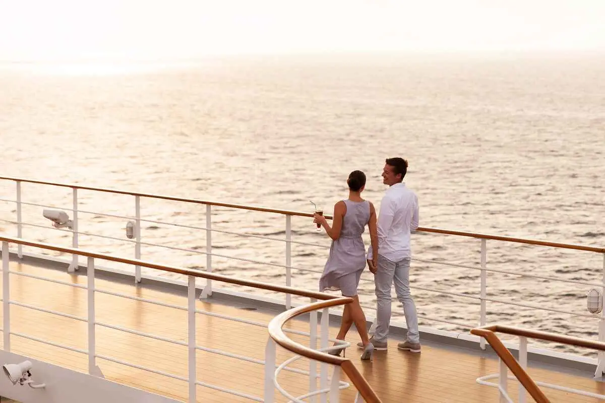 cruising - Best Travel Agents in NJ - JJ Travel Associates Couple walking on the deck of a cruise ship