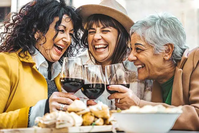 Happy women drinking wine - Best Travel Agents in NJ - JJ Travel Associates Friends drinking wine on a special interest vacation