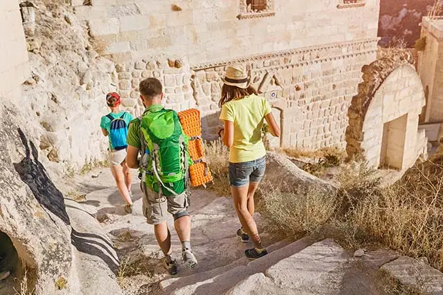 Ancient town in Cappadocia Turkey - Best Travel Agents in NJ - JJ Travel Associates Friends walking down the stairs of an ancient city