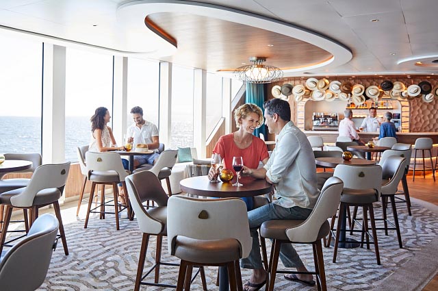 People relaxing in the Explorer Lounge on Celebrity Flora