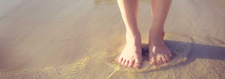 Relaxation travel - woman standing in shallow water
