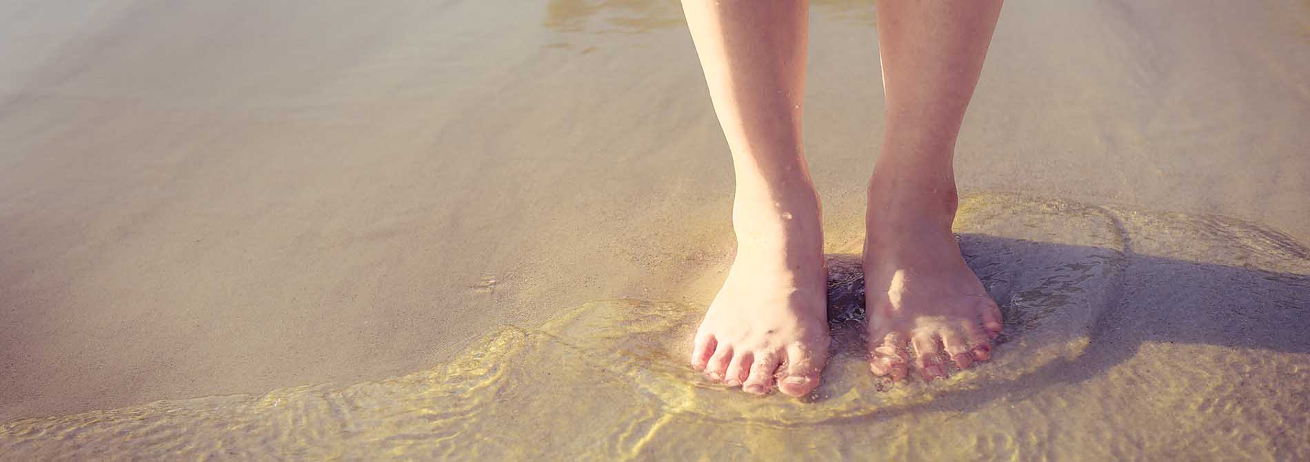 Relaxation travel - woman standing in shallow water